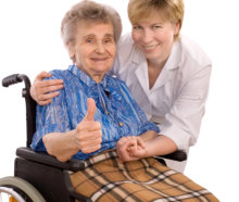 Elder in wheelchair with caregiver